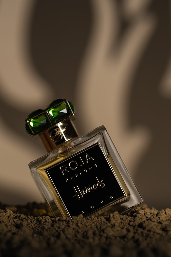 Elegant perfume bottle featuring luxurious design set against an artistic background.