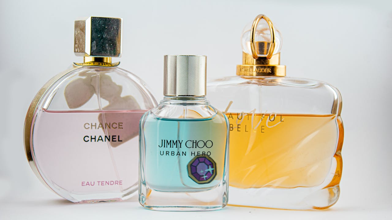 services-02 Elegant display of designer perfume bottles featuring Chanel, Jimmy Choo, and Estee Lauder.